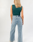 Back view of the Luck Of The Draw Green Ruched Funnel Neck Tank showing smooth fit and sleeveless cut. Styled with light wash wide-leg jeans.