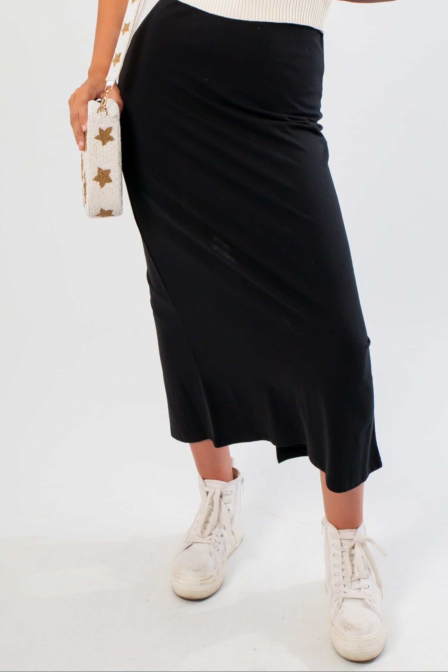 Close-up of Z Supply True Black Gail Midi Skirt showing soft cotton texture and sleek silhouette. A versatile black midi skirt for any occasion.