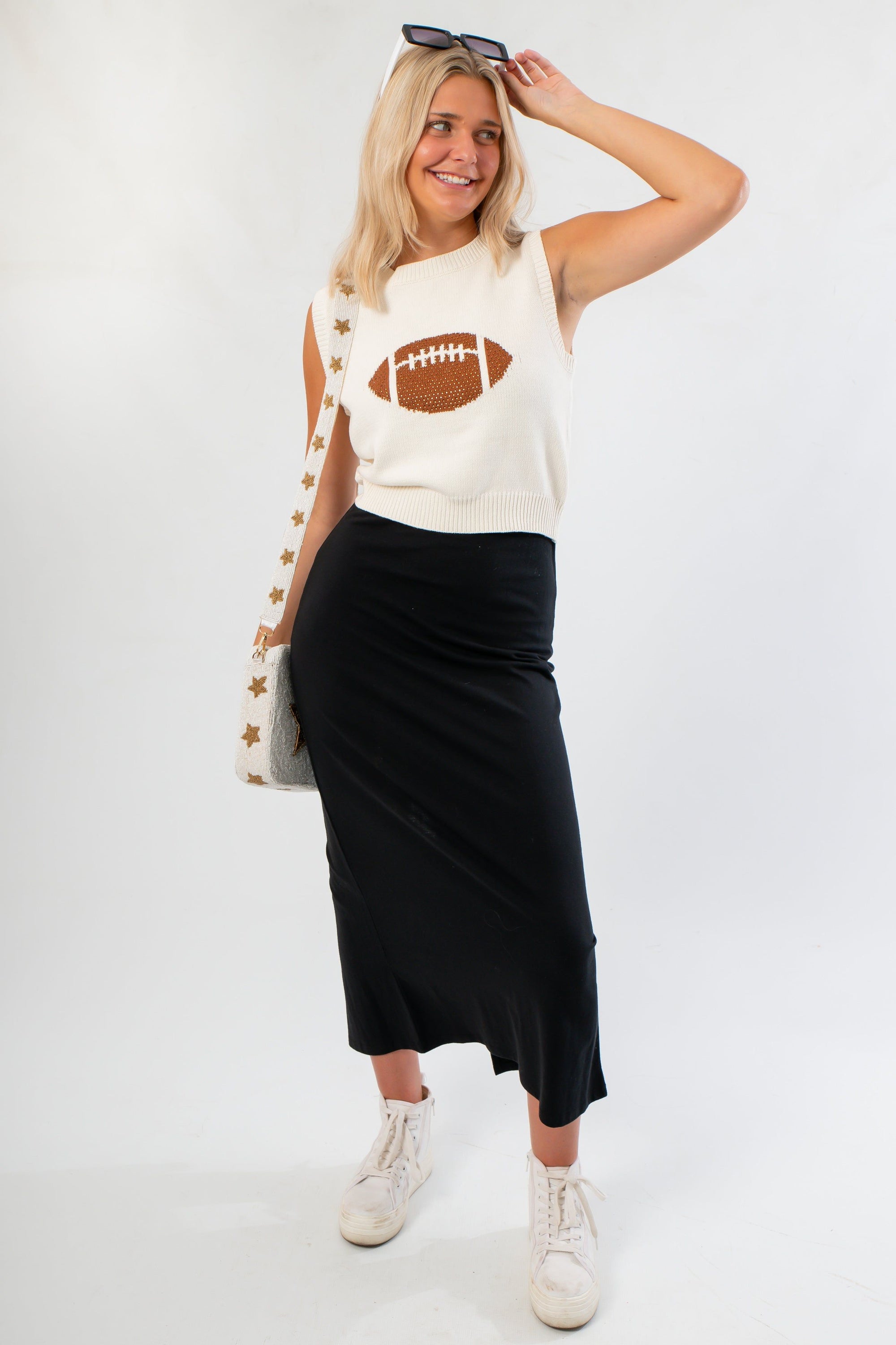 Football Sweater - Ned Bedazzled styled with black midi skirt and white sneakers, perfect for sporty and stylish game day looks.