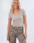Z Supply Heather Taupe Sirena Rib Tee with scoop neckline and cap sleeves, styled with leopard print pants for a casual-chic look.