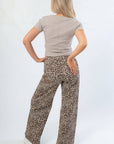 Back view of Z Supply Heather Taupe Sirena Rib Tee showing seam detail and fitted silhouette, paired with leopard print wide-leg pants.