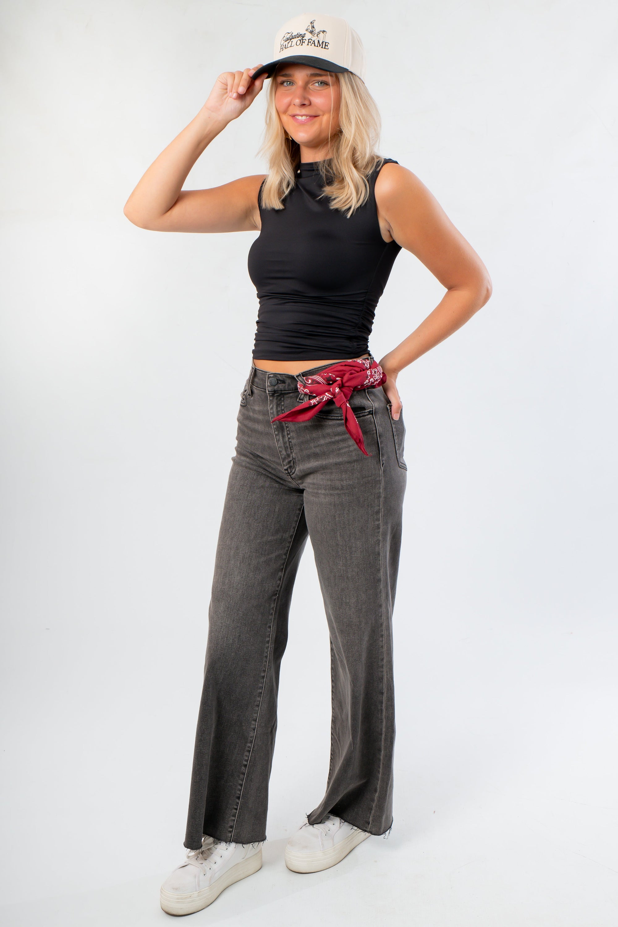 Sleek Luck Of The Draw Black Ruched Funnel Neck Tank paired with wide-leg grey jeans and white sneakers, ideal for layering or work wear.