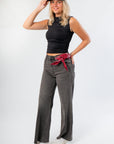 Sleek Luck Of The Draw Black Ruched Funnel Neck Tank paired with wide-leg grey jeans and white sneakers, ideal for layering or work wear.