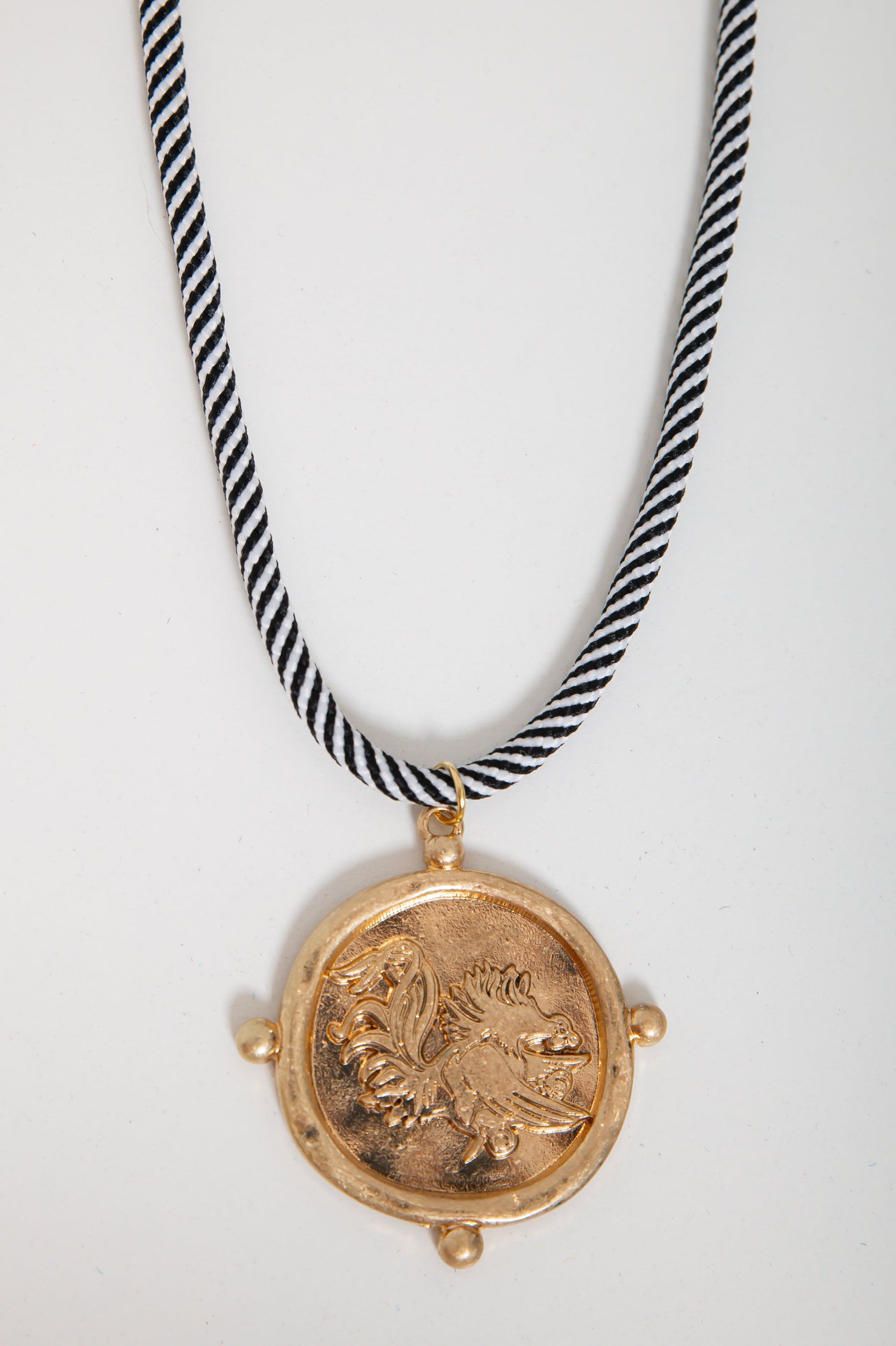 USC Gamecock gold pendant necklace featuring a corded black and white rope, ideal for fans seeking stylish gameday accessories.