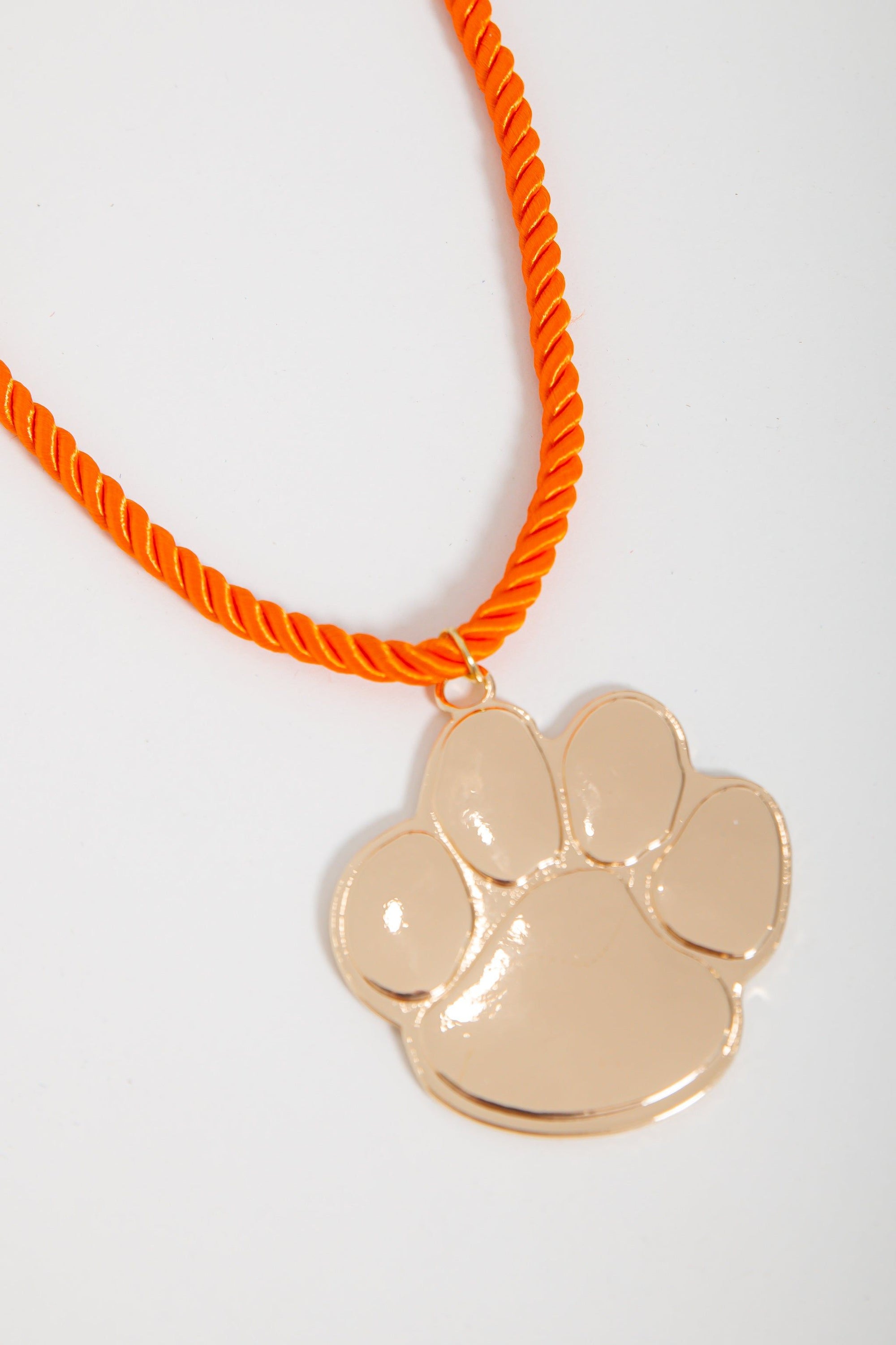 Go Team Gold Clemson Paw Corded Rope Necklace with bold gold paw pendant on bright orange twisted cord, ideal for Clemson Tigers gameday jewelry.