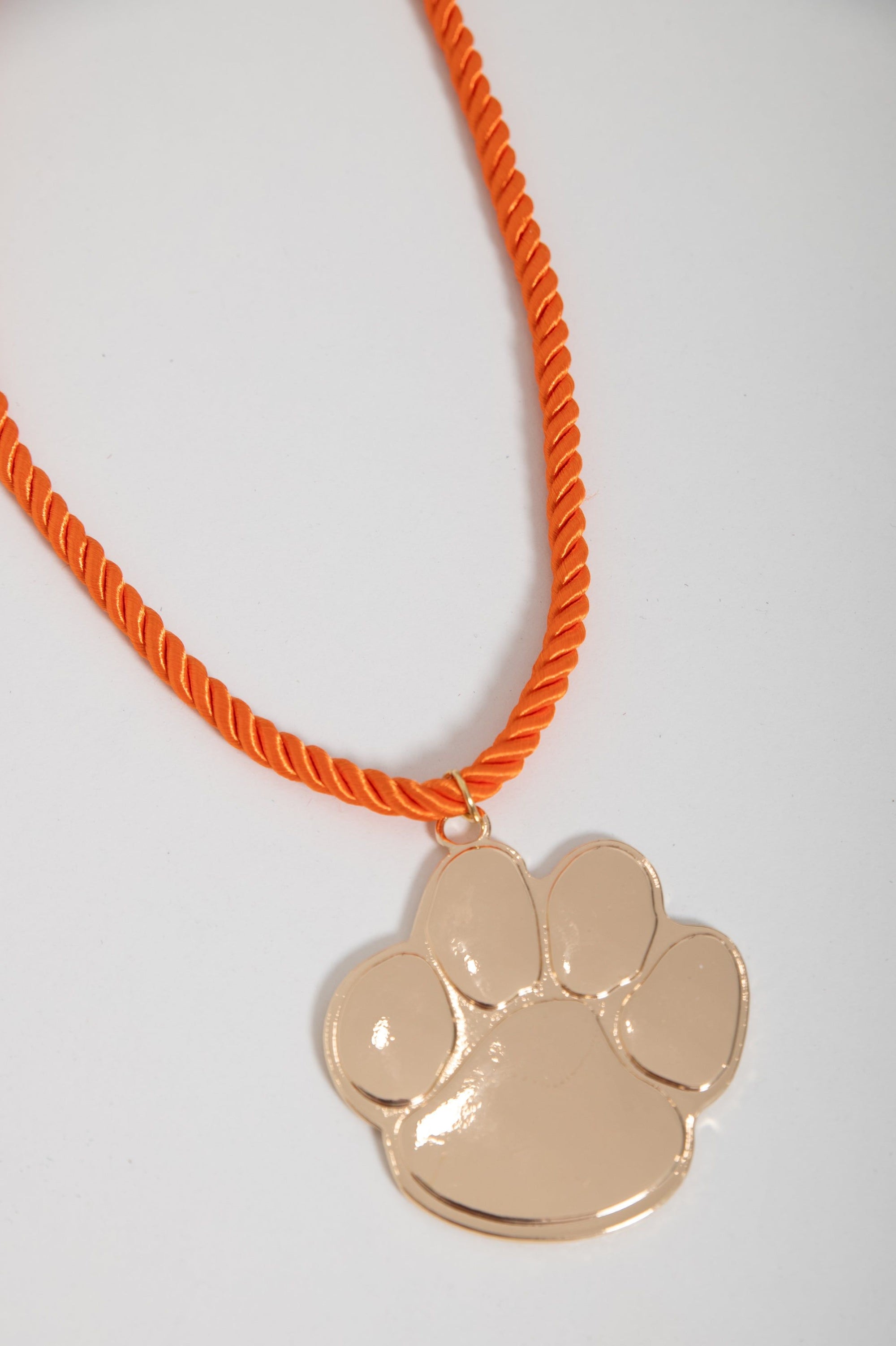 Gameday Jewelry Go Team Gold Clemson Paw Necklace featuring shiny gold paw charm and vibrant orange rope chain, perfect for Clemson fans.