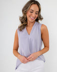 Model wearing Lavender Mist V-Neck Sleeveless Drape Top with a relaxed fit and subtle front pleat, ideal for work-to-weekend styling.