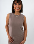 woman wearing taupe sleeveless tank top with jewelry, front view