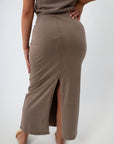 Back view of taupe midi skirt with slit and fitted design