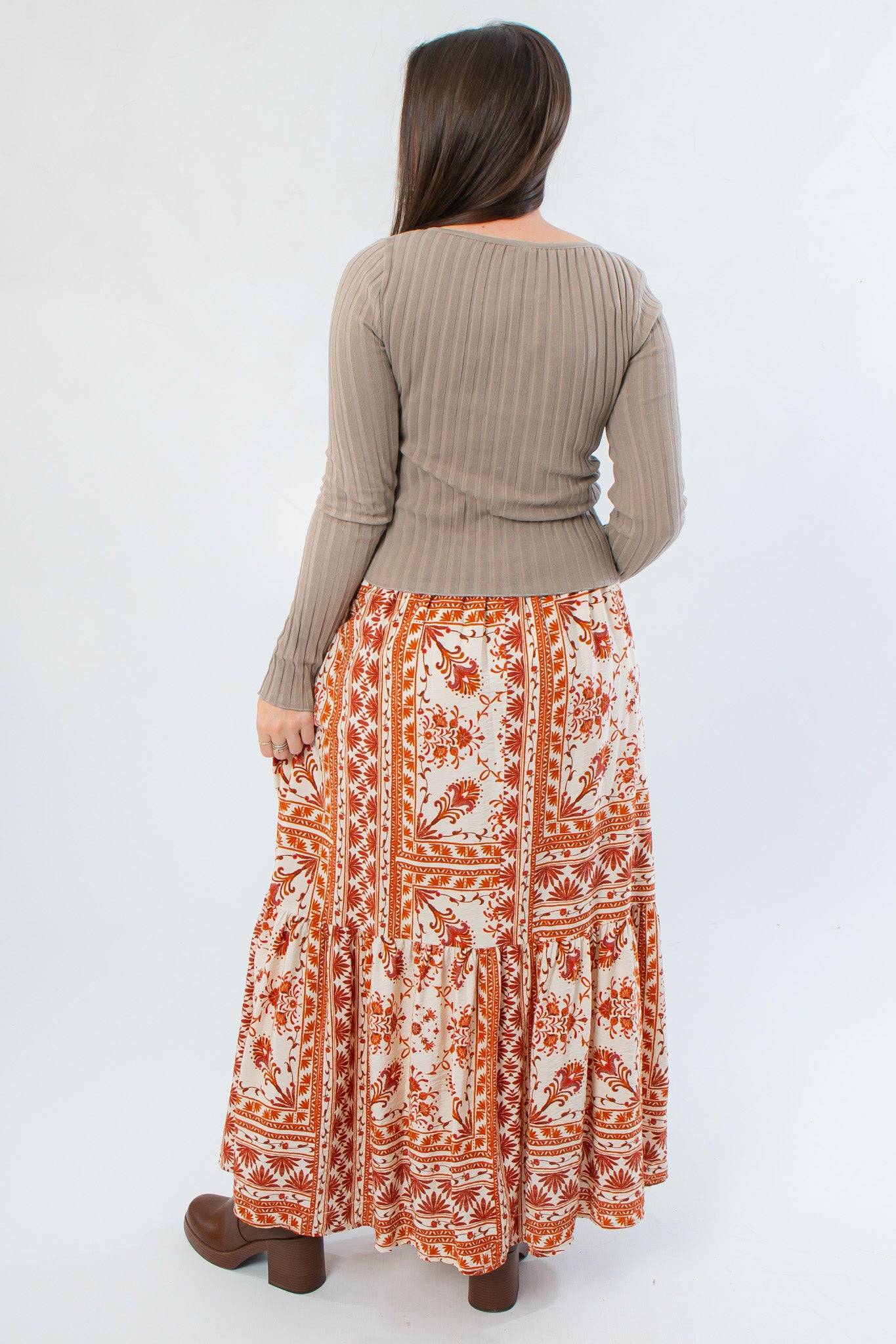 Back view of Burnt Orange Floral Patterned Midi Skirt showing flowy silhouette and detailed floral print. Great for fall wardrobes.