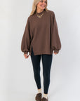 Front view of Camden Brown Ribbed Knit Mockneck Top featuring relaxed silhouette and side slit, ideal for casual layering.