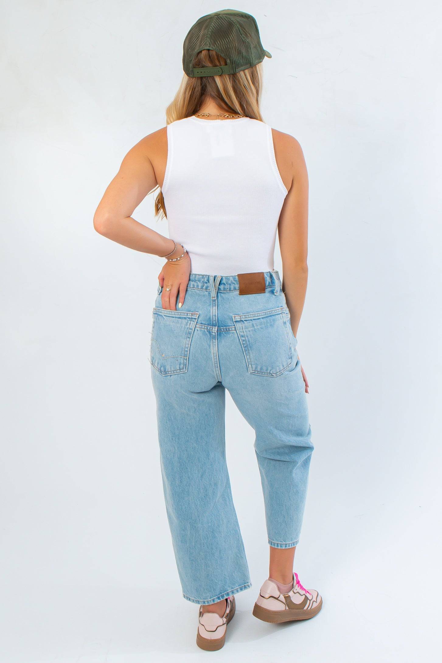 Back view of Off White Knit Tank Top – Stylish All-Season Crop Top featuring racerback design and snug fit, ideal for versatile everyday wear.