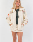 Autumn Blooms Cream Embroidered Denim Jacket with oversized fit and floral embroidery on front and sleeves, ideal for fall outerwear styling.