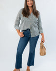 Dark Green Striped Button Down blouse paired with flared jeans and wedge sandals, showcasing a chic fall workwear look.