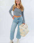 Before You Go Blue Stripe Long Sleeve Crop Top paired with wide-leg jeans, cream boots, and a printed tote bag for a stylish layered outfit.