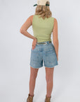 Back view of Free People Weeping Willow Tilly Vest in light green, styled with denim shorts and boots for a casual spring look.