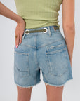 Back view of Free People Truest Blue Moxie Shorts highlighting rear patch pockets and grommet belt detail in vintage-inspired denim.
