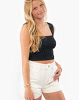 Trendy Off White High Rise Utility Cargo Shorts paired with a black crop top. Stylish and comfortable for casual summer outfits.