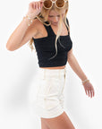 Side view of Off White High Rise Utility Cargo Shorts showcasing structured seams and utility-inspired design. Ideal for chic casual wear.
