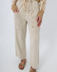 Breezy Natural Linen Cargo Pocket Pants with drawstring waist and wide leg fit, featuring front patch pockets and neutral beige tone.