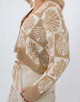 Side view of Cowrie Cutie Seashell Cardigan showcasing taupe and ivory coastal knit pattern and relaxed fit for casual layering.