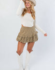Before You Go Cream Long Sleeve Crop Top – Chic & Comfortable paired with a tan mini skirt and white boots, perfect for fall layering and western-inspired looks.