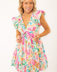 Meet Me in Santorini Aegean Garden Dress with deep V-neckline, flutter sleeves, and pink tie-front waist in vibrant floral print.