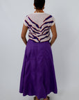 Paneled maxi skirt in deep purple with sleeveless sweater for a stylish game day look