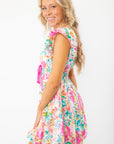 Side view of Meet Me in Santorini Aegean Garden Dress with ruffled sleeves and colorful floral print ideal for vacation or spring events.