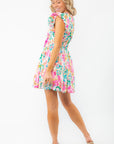 Back view of Meet Me in Santorini Aegean Garden Dress showing gathered waist and colorful floral pattern, perfect for spring and summer.