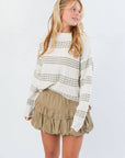 Paige Olive Stripe Textured Sweater with cozy knit and neutral olive stripes, styled with a khaki ruffle skirt for a chic fall look.