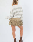 Back view of Paige Olive Stripe Textured Sweater highlighting its oversized fit and horizontal olive stripe pattern, ideal for fall outfits.