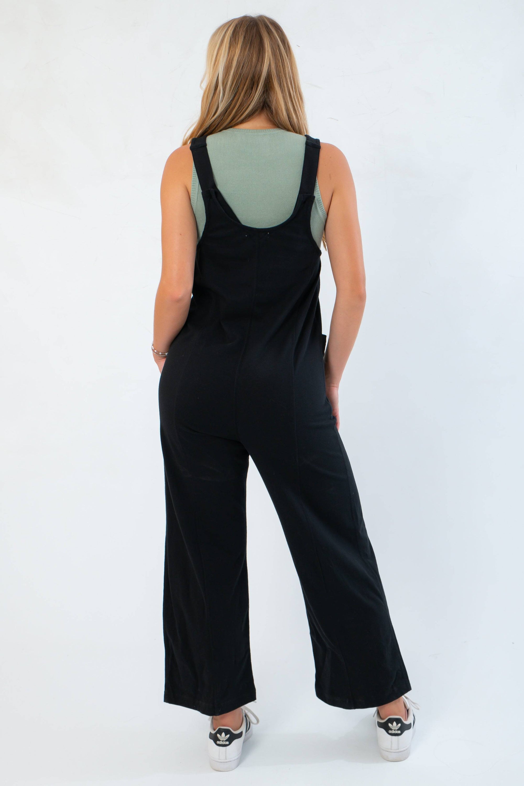 Back view of Z Supply True Black Everyday Jersey Jumpsuit with wide straps and relaxed silhouette, perfect for layering and casual outfits.