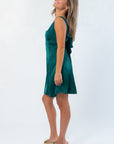 Side view of HYF Dark Green Mini Dress highlighting the soft satin fabric and stylish tie back, a chic choice for any occasion dress.