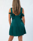 Back view of HYF Dark Green Mini Dress showcasing elegant bow tie straps and smooth satin finish, perfect for special events or parties.
