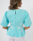 Back view of aqua floral poplin top with puff sleeves