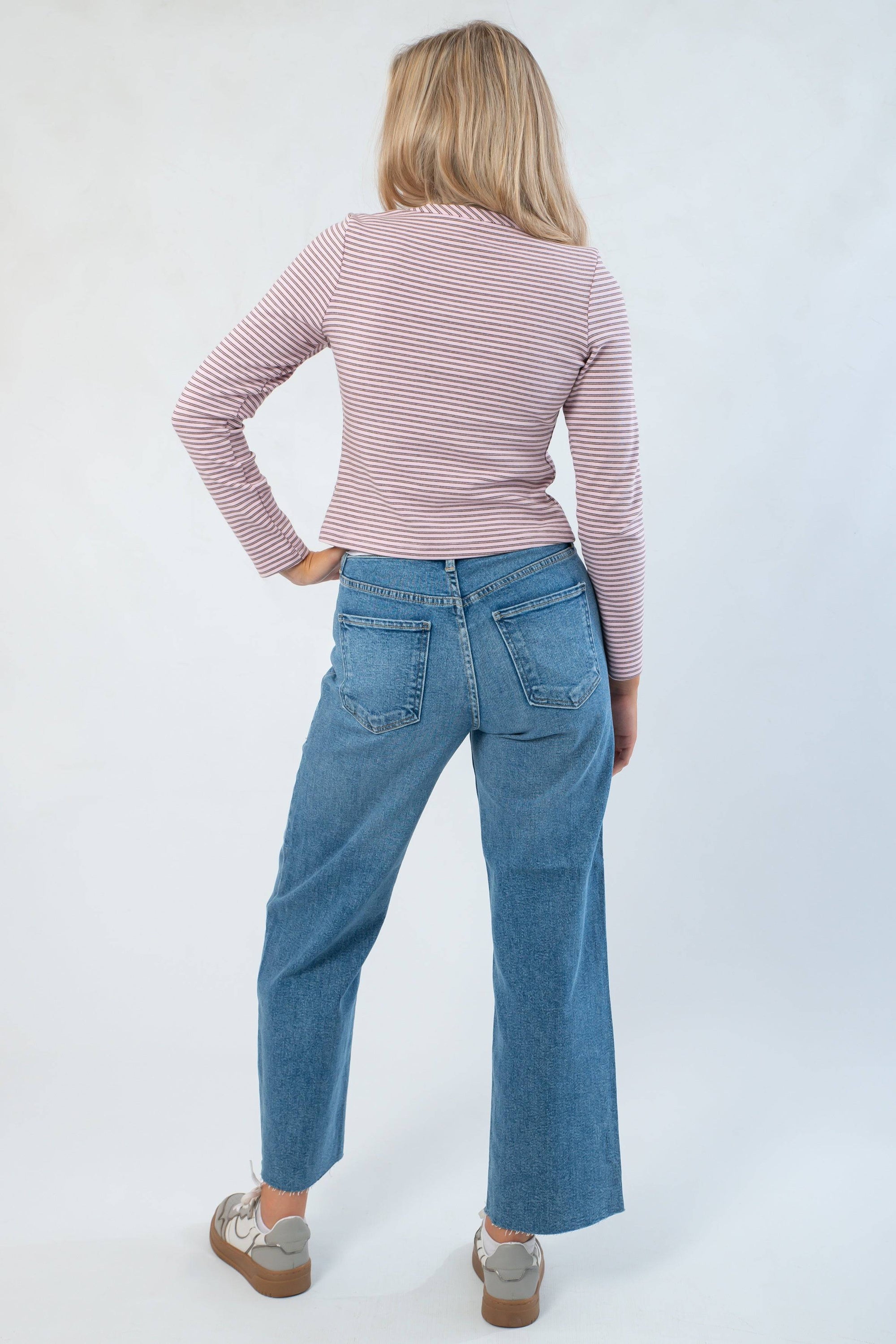 Back view of Carry On Pink & Brown Striped Button Front Top highlighting its snug fit and horizontal stripe pattern, styled with denim jeans.