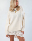 Almost September Off White Cream Oversized Sweater with mock neck and ribbed cuffs, styled with lace mini skirt for cozy fall fashion.