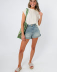 Frankie White Knit Sleeveless Sweater styled with shorts