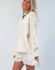 Side view of the Almost September Off White Cream Oversized Sweater showcasing its relaxed fit and soft knit texture for fall layering.
