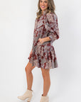 Side view of Scottie Burgundy Print Tiered Mini Dress showcasing flared skirt and relaxed fit, great for casual and patterned dress collections.