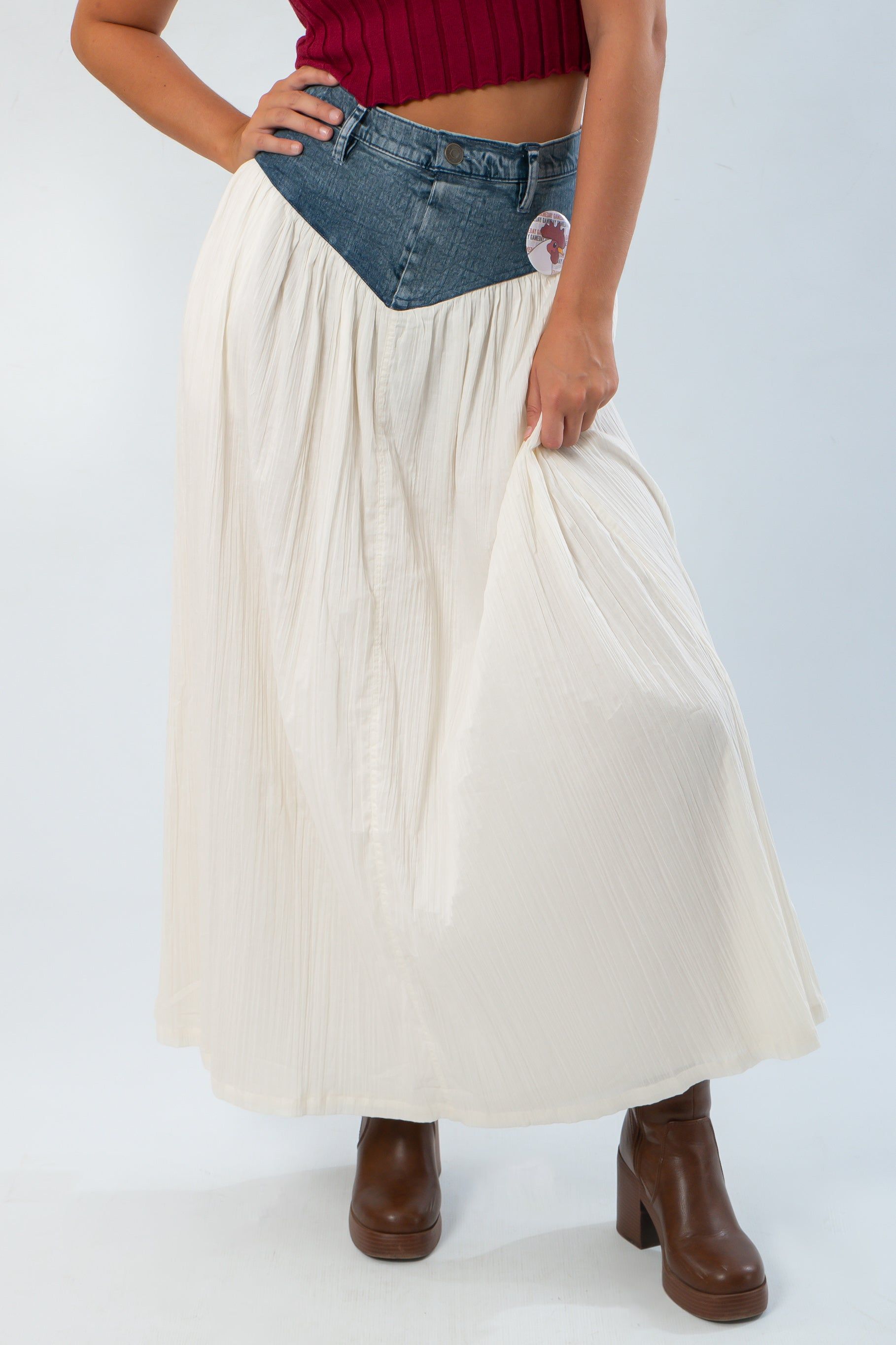 Denim Voile Maxi Skirt - Show Me Your Mumu featuring a cream pleated skirt with a denim waistband, styled with brown boots.