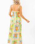 Back view of the Show Me Your Mumu Peyton Country Bouquet Midi Dress showcasing its smocked bodice, adjustable straps, and flowing floral skirt.