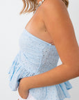 Back view of blue eyelet halter top with tie closure