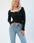 Free People Black Oh My Darling Long Sleeve – Slim Fit Lace Top with scoop neckline and ruffled cuffs, styled with light-wash jeans.