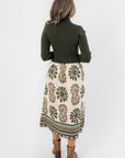 Back view of Channing Olive Green Contrast Midi Dress highlighting the seamless transition from ribbed bodice to floral midi skirt.