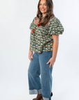 Side view of THML Green Floral Color Block Puff Sleeve Top showing puff sleeves and floral pattern, styled for autumn wear.