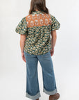 Back view of THML Green Floral Color Block Puff Sleeve Top highlighting the color block yoke and floral print, perfect for fall styling.