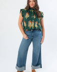 THML Dark Green Ruffle Sleeve Block Floral Print Blouse with flutter sleeves and high neck, styled with wide-leg cuffed jeans for fall fashion.