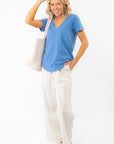 Effortless style with Z Supply Asher V-Neck Tee in Riviera Blue, paired with wide-leg striped pants and woven accessories for a laid-back look.